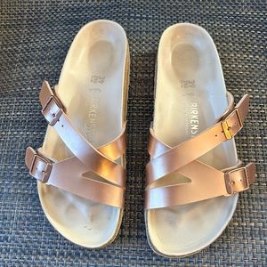 Woman’s Birkenstock rose gold sandles